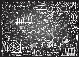 Complicated equations on chalkboard - istock