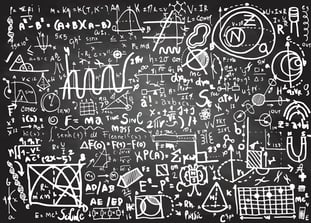 Complicated equations on chalkboard - istock