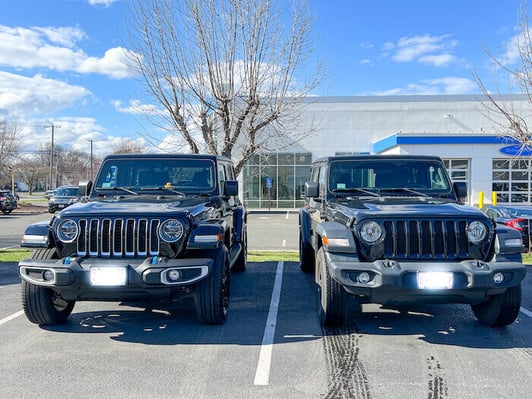 two wranglers (one EV) parked side by side from the front