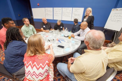 Facilitator working with a small group at community event