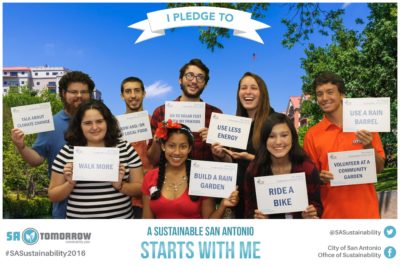 People holding signs pledging sustainability actions