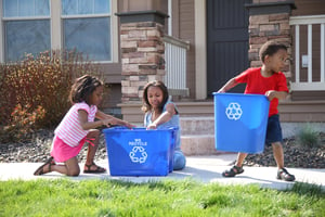 Three-children-putting-items-into-recycle-bin-93099254_2700x1800