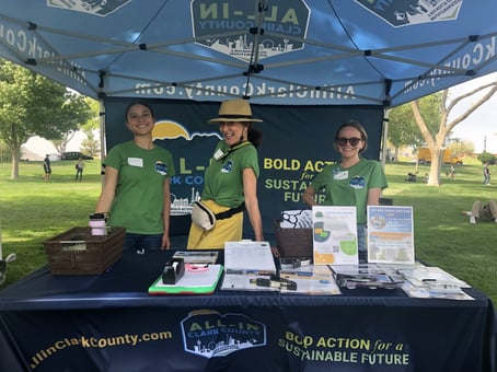 Photograph of Clark County climate ambassadors smiling at an All-In tabling event