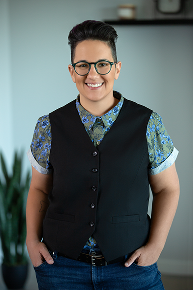 Smiling woman posing with hands half in pockets