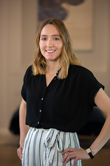 Woman smiling with hands on both hips
