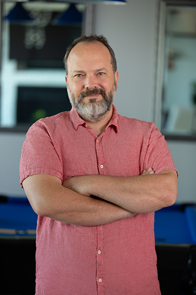 Man posing with arms crossed in front of chest